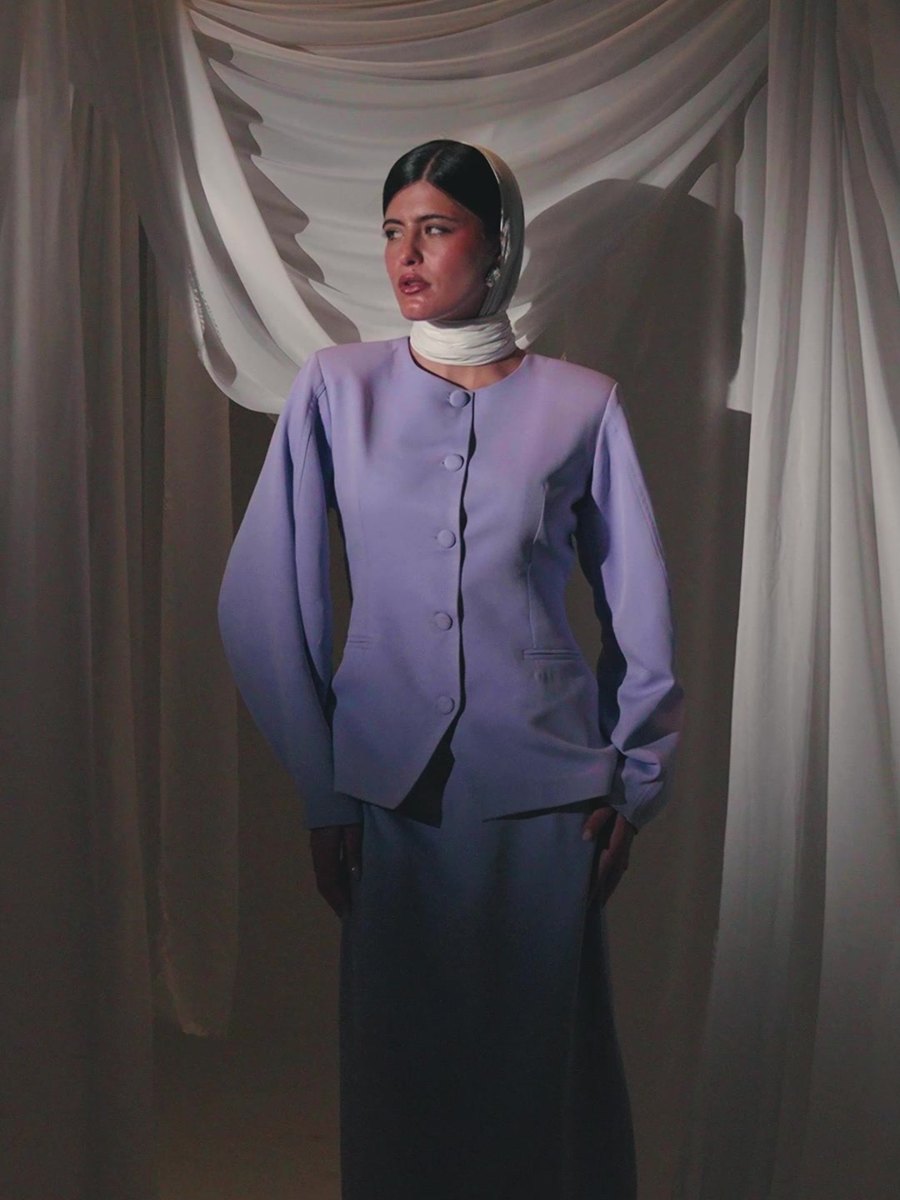 The Silhouette Blazer in lilac, worn with a cream veil before draped fabric
