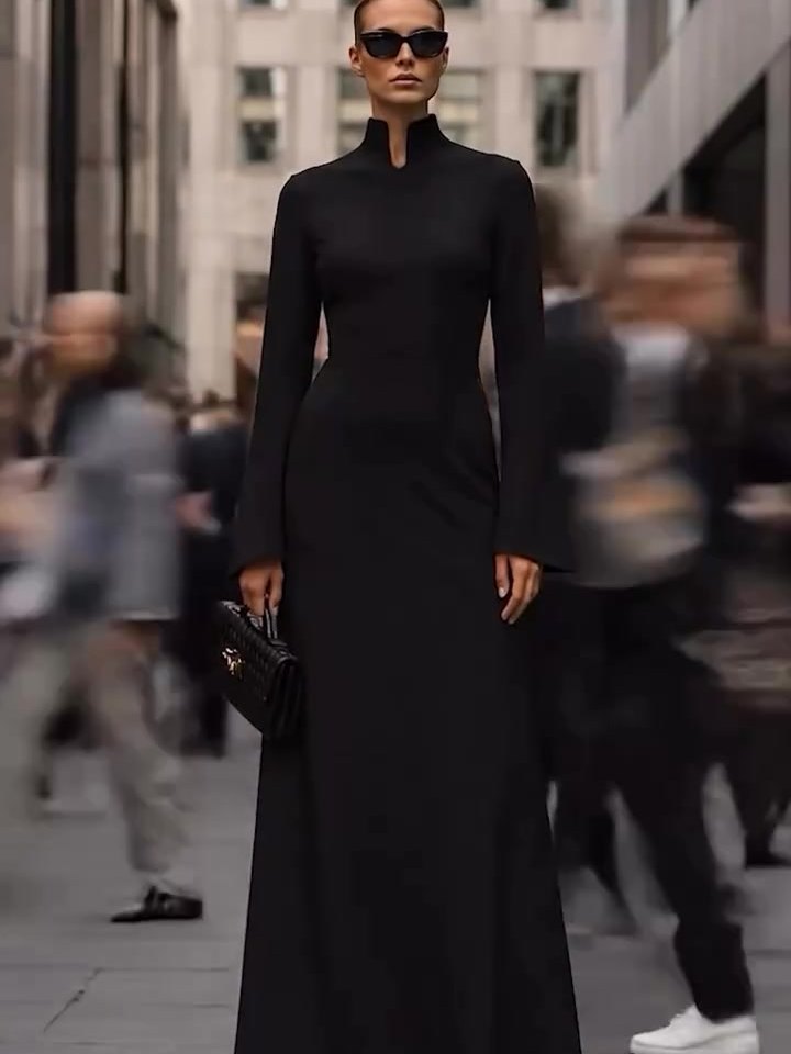 The Japanese Collar Maxi Dress in black, worn on a busy city street